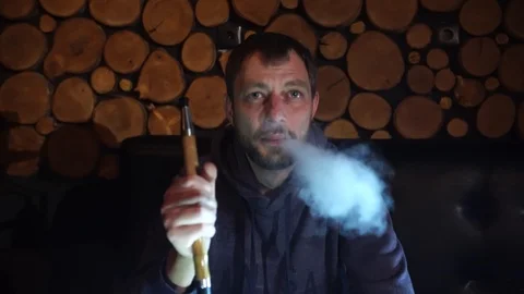Man smokes hookah in a bar. Stock Footage 90431287