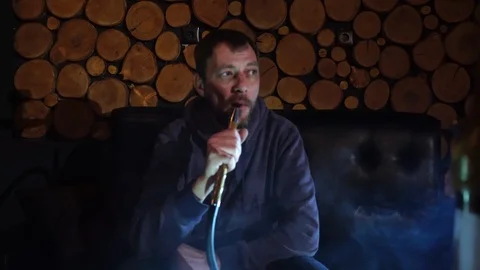 Man smokes hookah in a bar. Stock Footage 90431652