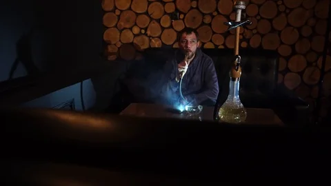 Man smokes hookah in a bar. Video stock 90431828