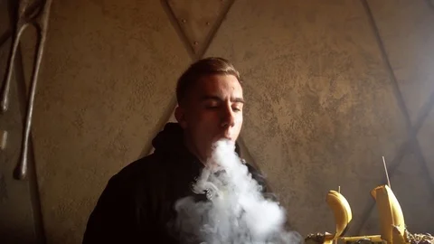 Man smokes a hookah in a bar Stock Footage 122951464