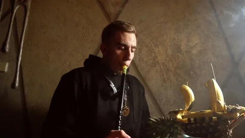 Man smokes a hookah in a bar Stock Footage 122951466
