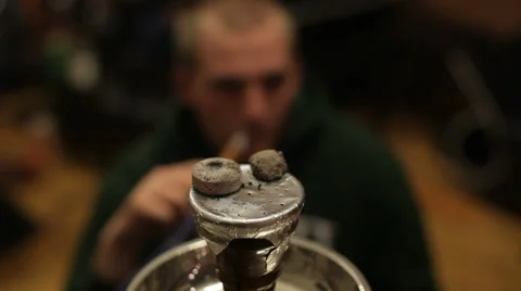Man smokes hookah Stock Footage 61724683