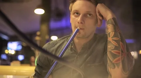 Man smokes hookah Stock Footage 65259500