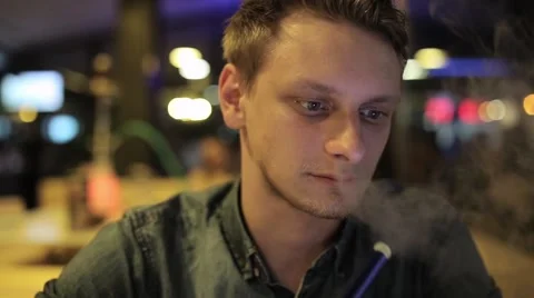 Man smokes hookah Stock Footage 65259687