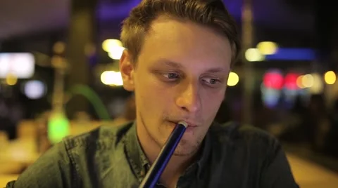Man smokes hookah Stock Footage 65259867