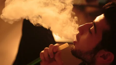 Man smokes a hookah Stock Footage 68480393