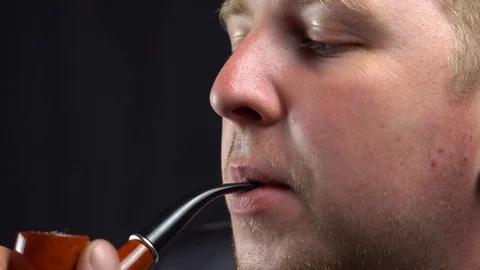 A man smokes a pipe Stock Footage 91085836