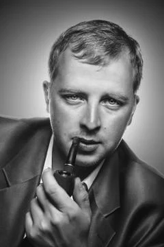 A man smokes a pipe Stock Photos
