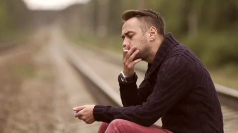 Man smokes on the rails. Stock Footage 67853835