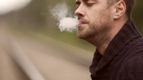 Man smokes on the rails. Stock Footage 67853836