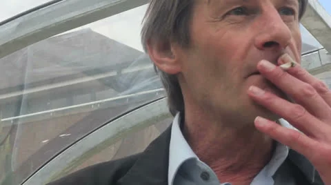 Man smokes roll up Stock Footage 25169810