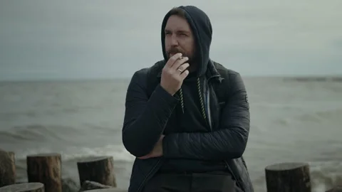 Man smokes on the seashore Stock Footage 156564035