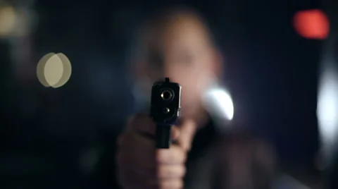 A man smokes then pulls out a gun and aims at the viewer. Smoking kills. Stock Footage 43888790