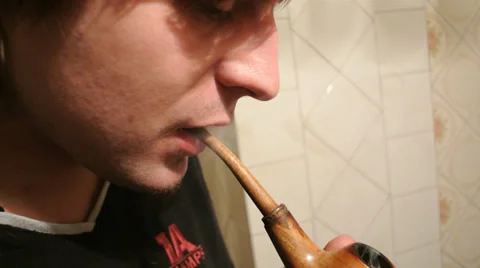 Man smokes a tobacco pipe Video stock 33848053