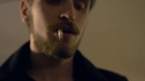 A man smokes in an underground passage Видео 81595607