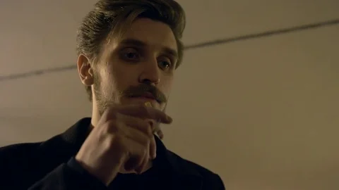 A man smokes in an underground passage Видео 81595627