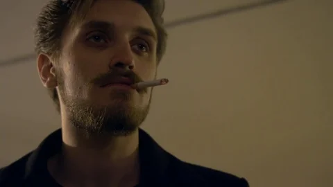 A man smokes in an underground passage Видео 81595781