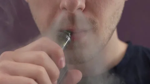 A man smokes a vape. vaping. electronic cigarette. steam. Stock Footage 209568103