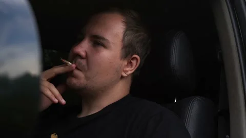 Man smokes while sitting in the car Stock Footage 158815198