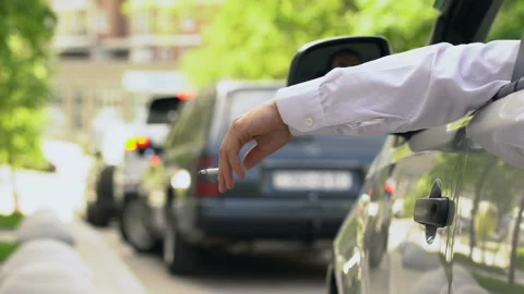 Man smoking in auto, dumping cigarette ash on street, stuck in traffic jam Stock Footage 91610429