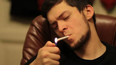 Man smoking in a chair Stock Footage 61925388