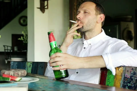 i like drinking beer and smoking cigarettes Man smoking cigarette and drinking beer at home NTSC
