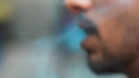 Man Smoking Cigarette Close-Up with Dramatic Lighting Stock Footage 333070019