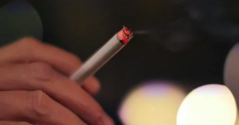 Man smoking cigarette, closeup on hand, shallow DOF. 4K UHD. Stock Footage