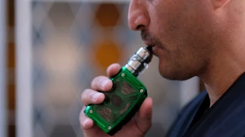 A man smoking an electronic cigarette Stock Footage 241741352
