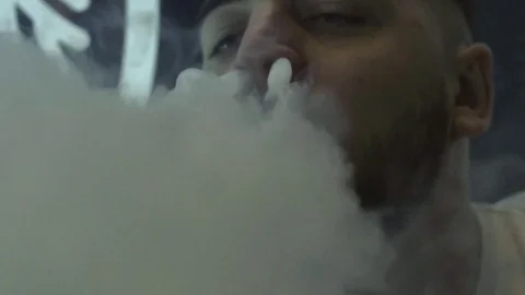 Man is smoking a hookah in the dark close-up 스톡 동영상 85187835