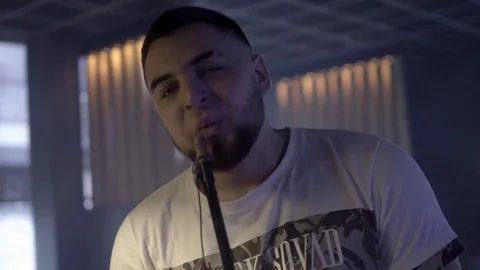 Man is smoking a hookah in the dark Stockbeeldmateriaal 85187475