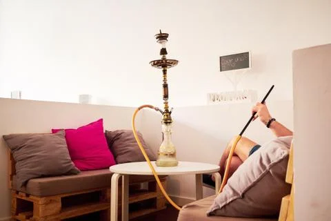 Man smoking hookah Stock Photos