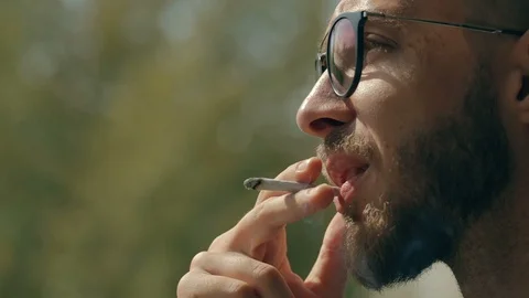 Man smoking a joint Video stock 95039373
