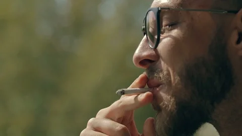 Man smoking a joint Video stock 95039392