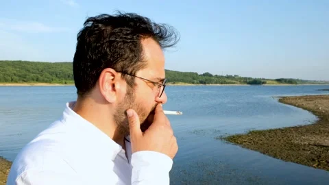 Man smoking by lake Stock-Footage 201248537