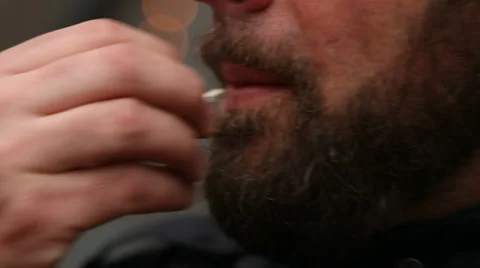 Man smoking marijuana, blows to camera, close up Stock Footage 36230138