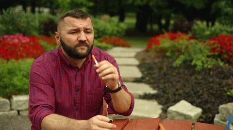 Man is smoking in the park Stock Footage 65818851