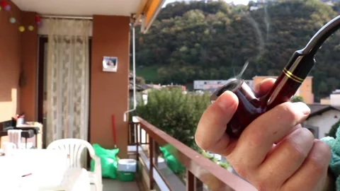 Man is smoking a pipe Video stock 171608283