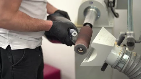 Man smoothing prosthesis with sander in factory Stock Footage 236623660