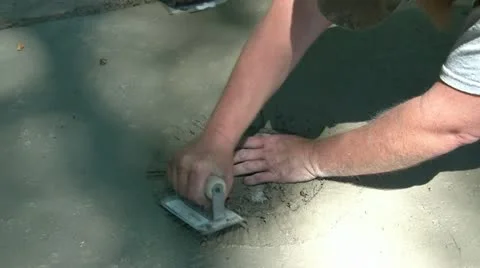 Man Smooths Cement with Trowel Video stock 12598441