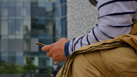 Man sms texting using app on smart phone in city HD Video stock 78657818