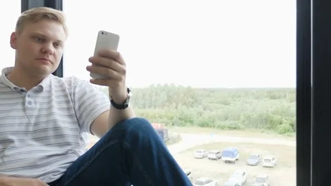 Man sms texting using app on smart phone at night in city. Handsome young Stock Footage 81466405