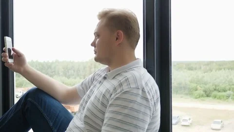 Man sms texting using app on smart phone at night in city. Handsome young Stock Footage 81466823