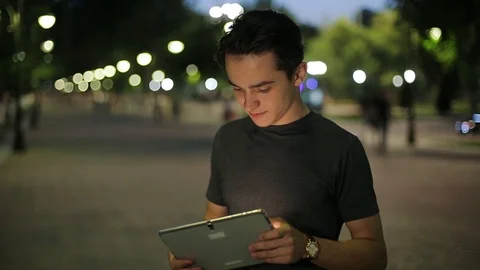 Man sms texting using app on smart phone at night in city.  Stock Footage 90758078