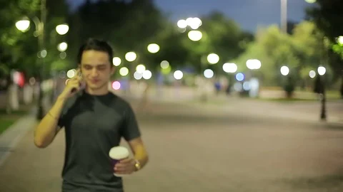 Man sms texting using app on smart phone at night in city.  Stock Footage 90760844