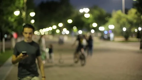 Man sms texting using app on smart phone at night in city.  Stock Footage 90761339