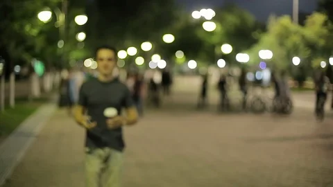 Man sms texting using app on smart phone at night in city.  Stock Footage 90762032