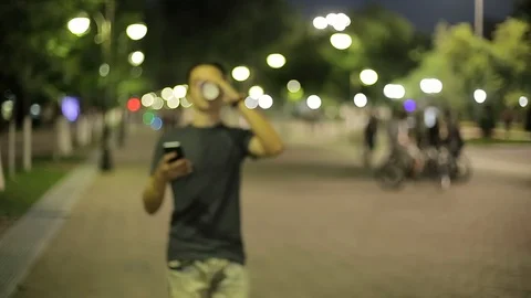Man sms texting using app on smart phone at night in city.  Stock Footage 90763078