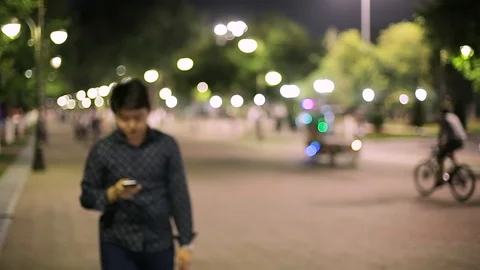 Man sms texting using app on smart phone at night in city. Stock Footage 90775555