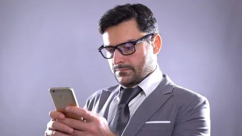 Man sms texting using on smart phone at night in city. Handsome young business Stock Footage 101634075